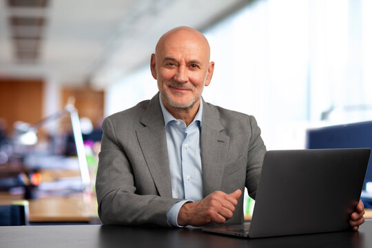 Portrait of a confident mature businessman working at his office desk