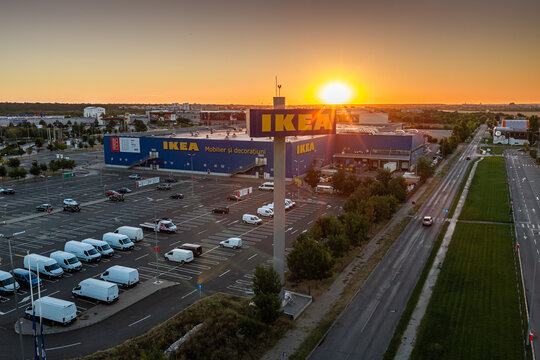 Bucharest, Romania Aerial scenic view of IKEA Baneasa department store and parking lot under warm sunrise with vibrant orange glow.
