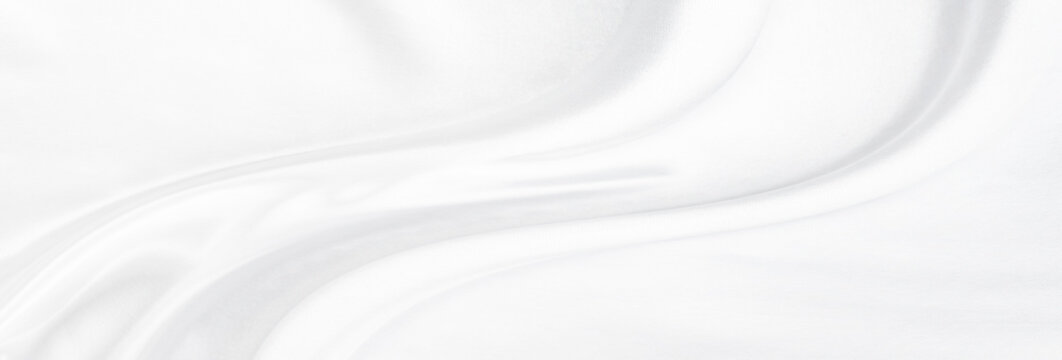 White gray satin texture that is white silver fabric silk panorama background with beautiful soft blur pattern natural.