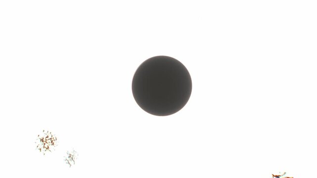 Dark silhouette sphere floats against an overexposed white light field with eerie creeping tendril shapes in a 3D motion graphic