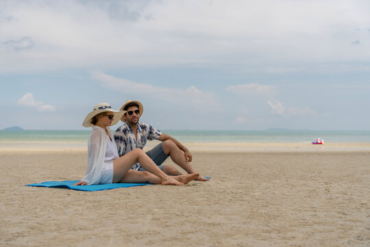Couple relaxing on a quiet sandy beach