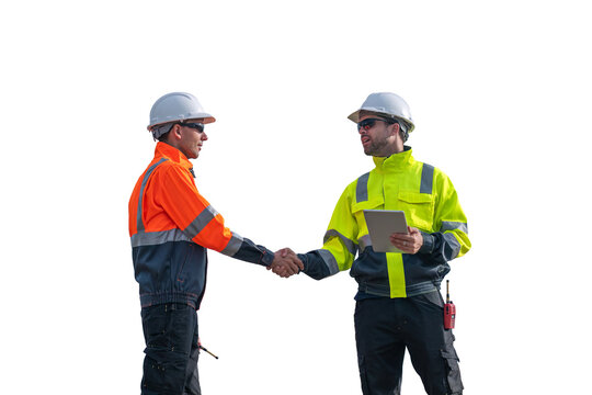 Engineers wearing safety gear, including hard hats examining survey standing industrial facility engaged in a job requires high safety standards concept with PNG white background.
