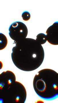 Glossy black liquid metaballs float and merge in vertical perspective against bright white space in a 3D animation