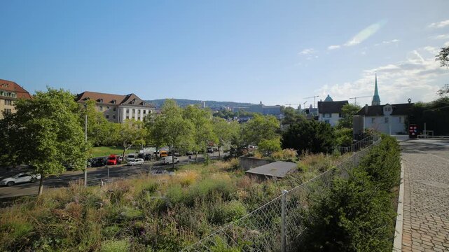 Zurich city park, street traffic and ETH university hill background
