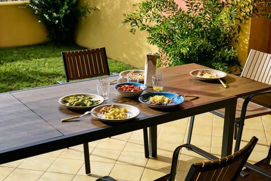 Healthy Breakfast Served on Wooden Table on Outdoor Patio