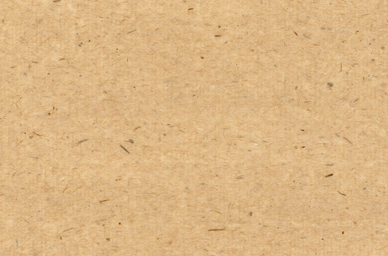 Handmade paper texture with visible recycled fibers and speckled kraft surface, warm craft sheet for scrapbooking and collage artwork with printable overlays for rustic packaging projects