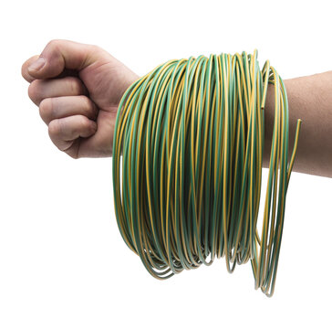 A fist is shown with a coil of green and yellow striped wire wrapped around the wrist