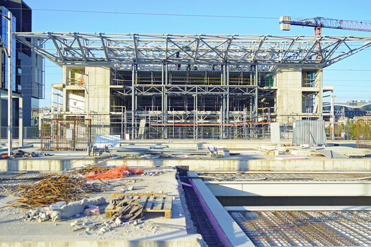 Large unfinished railway station with exposed multi-level steel roof truss. Captures major transit hub development, public infrastructure investment, and structural skeleton before cladding.