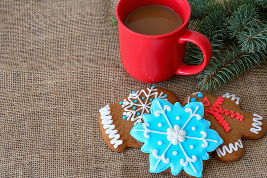 red mug with Coffee and Gingerbread Cookies on Burlap Background, copy space