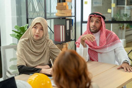 Diverse coworkers planning a construction project