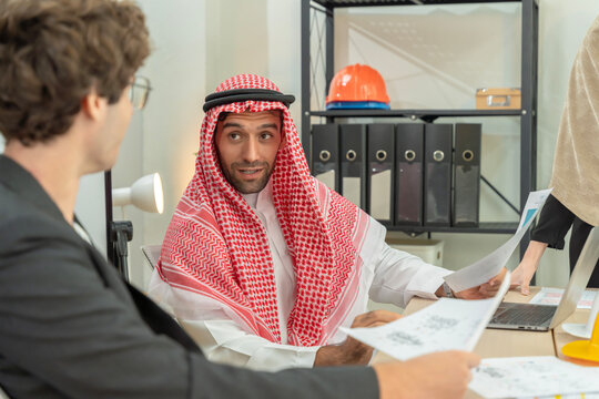 Arab Businessman Discussing Construction Plans in Office