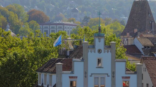 Historic guild houses and rooftops in Zurich old town skyline and Zurich Flag