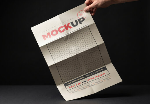 Hand Holding Folded Poster in Eight Parts Mockup