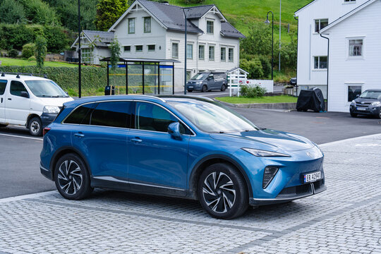 August 17, 2026, Eidfjord, Norway - Blue Nio electric SUV parked on a cobblestone street