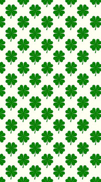 Seamless pattern of green four-leaf clovers symbolizing luck and St. Patrick&rsquo;s Day celebration.
