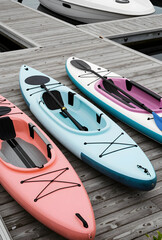 Fototapeta premium Recreation and outdoor adventure, colorful kayaks moored on a wooden dock for summer water sports and leisure travel activities at a lake marina