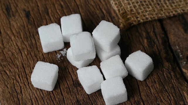 close up of white sugar cubes. sugar cube on the wooden background
