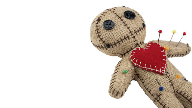 Creepy voodoo doll toy with pins in its red heart isolated on transparent background