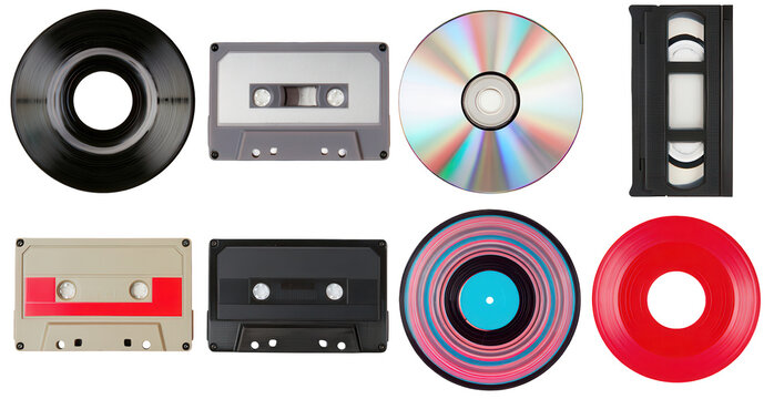 Collection of vintage media storage items including cassette tapes, vinyl records and VHS