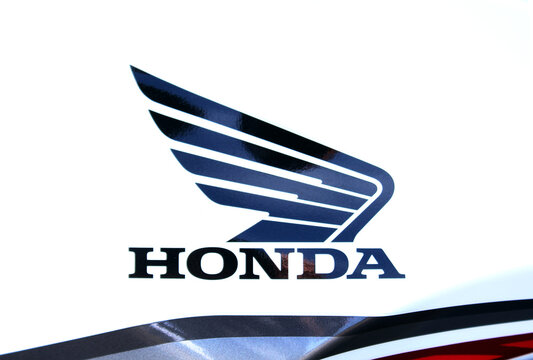 Vinnytsia, Ukraine; September 05, 2026. Honda motorcycle logo, Honda Gold Wing, bike emblem on glossy white moto tank, featuring dark blue lettering, sleek wing emblem, curved body lines. Moto logo Ho