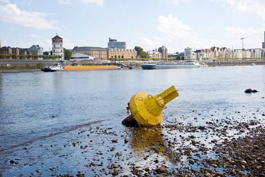 D&uuml;sseldorf, Germany, Low stream gauge of rhine river.Due to heat, drought, climate change and global warming ships can only operate with reduced cargo