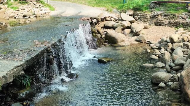 Mini water fall on the roadside footage