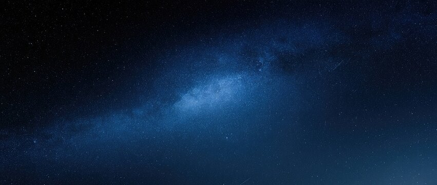 A dark, deep blue expanse speckled with faint stars and cosmic dust