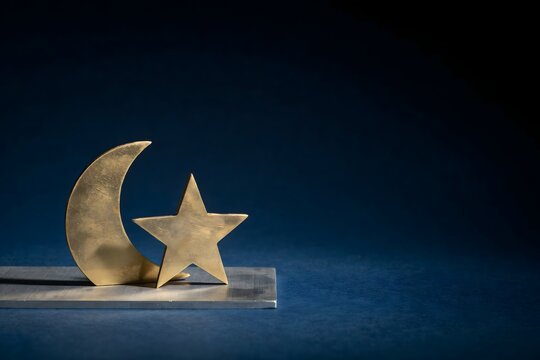 Gold crescent and star figure standing on a metal ledge &ndash; Great for Ramadan campaigns, cultural design, or minimal holiday backdrops