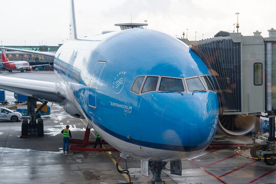 August 21, 2026, Amsterdam, Netherlands - Air France-KLM Group aircraft parked at Schiphol Airport gate with ground crew