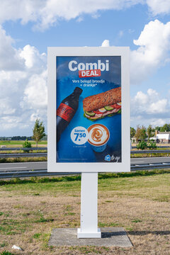 August 21, 2026, Amsterdam, Netherlands - Billboard advertising an AH to go combi deal with a sandwich, Coca-Cola, and coffee next to a road