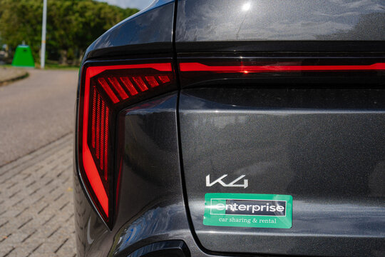 August 21, 2026, Amsterdam, Netherlands - Rear view of a dark grey Kia K4 car with an Enterprise car sharing & rental sticker