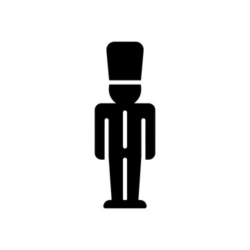 Minimalist black nutcracker toy soldier icon standing in a stiff formal posture for festive holiday decor