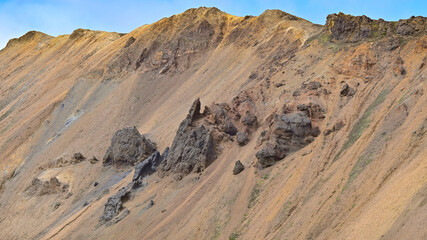 Dramatic eroded mountain slopes with exposed rock create a striking landscape in Landmannalaugar, Icelandic highlands. © Asanee