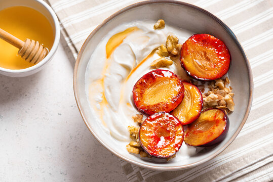 Roasted plums with yogurt, honey and nuts