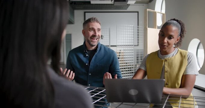 Team Discussing and Collaborating in Business Meeting Around a Table in Modern Office