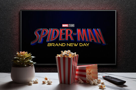 TV screen playing Spider-Man Brand New Day trailer or movie. TV with remote control, popcorn boxes and home plant. Astana, Kazakhstan - July 31, 2026.