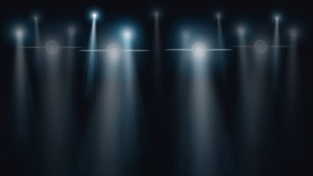 Bright stage spotlights casting vertical blue beams of light against a dark background