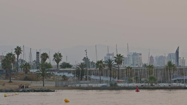 sun rising over the horizon on a hazy morning in barcelona