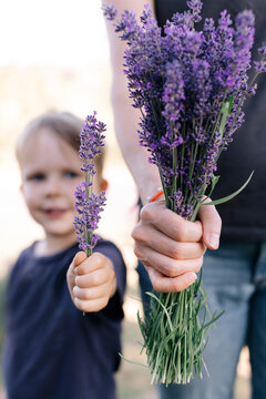 Boy and mom hold bundle of lavender