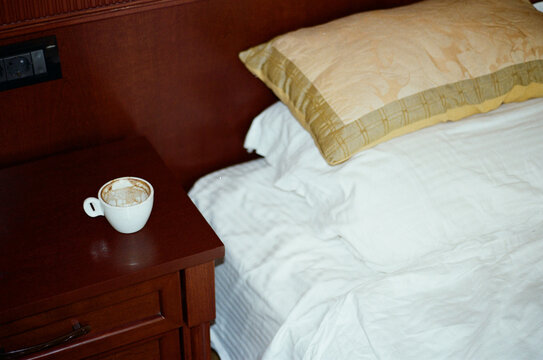 Morning Coffee on Bedside Table in Cozy Bedroom