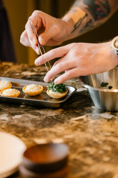 Chef's hands plating small savory canap&Atilde;&copy;s in luxury restaurant.