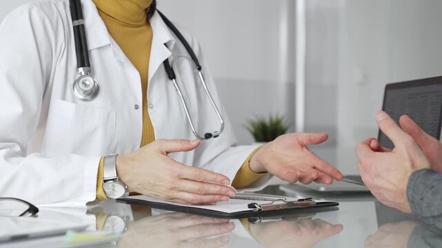 Doctor writing prescription during patient consultation in clinic, providing medical care and diagnosis. Medicine, healthcare and science concept