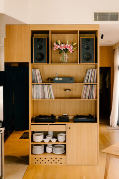 Wide shot of a stylish restaurant shelf with vinyls and turntables.