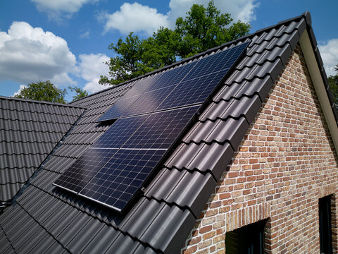 Solar Panels on a House Roof During a Sunny Day