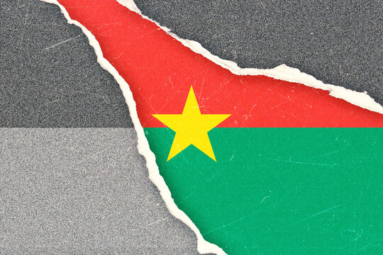 Burkina Faso National Flag Revealed Through Torn Distressed Paper Texture on a Grunge Background Symbolizing Political Crisis or National Struggle