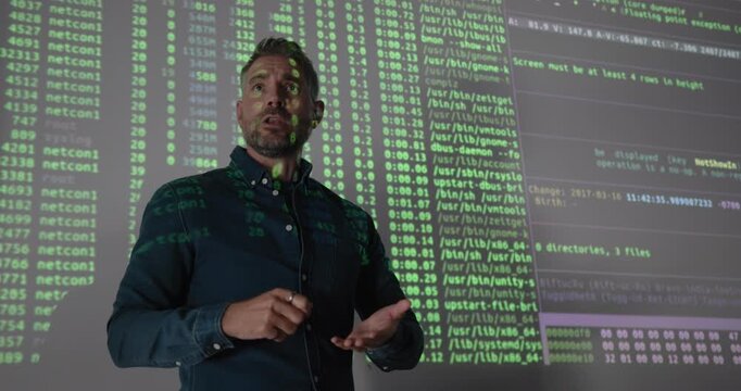 Mature Male Technology Expert Teaching Coding on Projection Screen