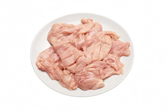 Fresh raw sliced chicken breast meat on white plate