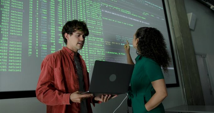 Two Young Technology Experts Looking at Data Analysis on Screen