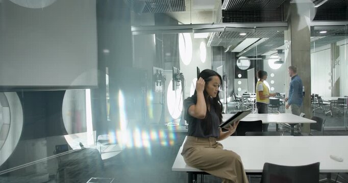 Young Professional Reading on Tablet in Office