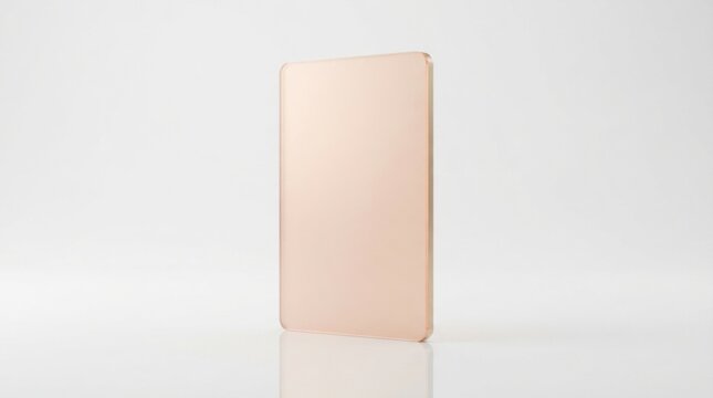Modern thin rose gold metallic rectangular plate standing on a clean white surface